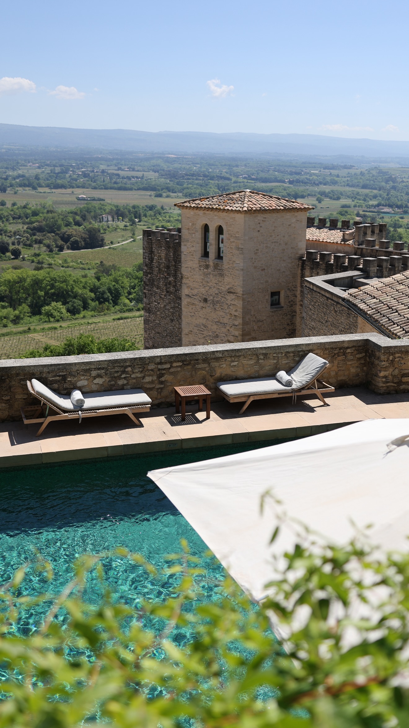 A pool and stone tower above the vineyards, near Crillon le Brave